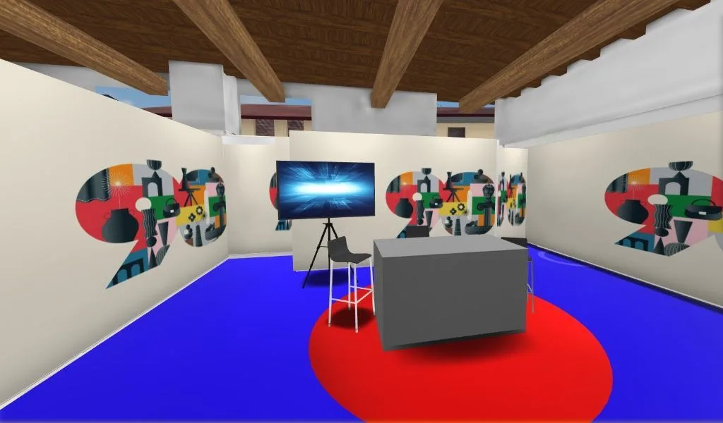 3D-Basismodell eines Messestands mit farbigen Wandgrafiken, grauem Desk, Bildschirm auf Stativ, blauem Boden und rundem rotem Teppich